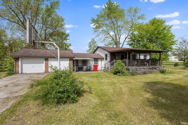view of front of house with driveway, a porch, a front yard, and an attached garage