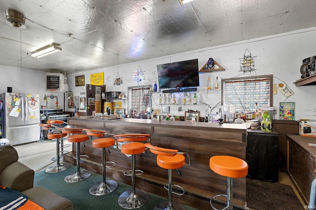 indoor dry bar with freestanding refrigerator