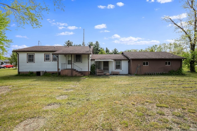 back of property featuring a yard