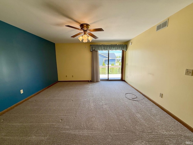 carpeted empty room with a ceiling fan and baseboards