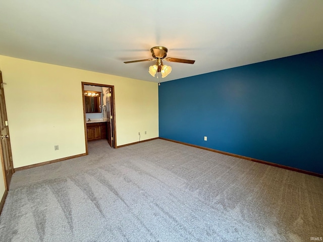 unfurnished room with ceiling fan, light colored carpet, and baseboards