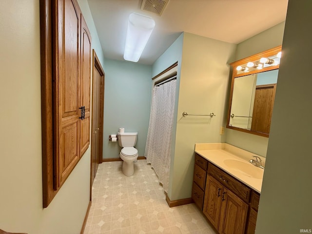 full bath featuring toilet, vanity, baseboards, and tile patterned floors