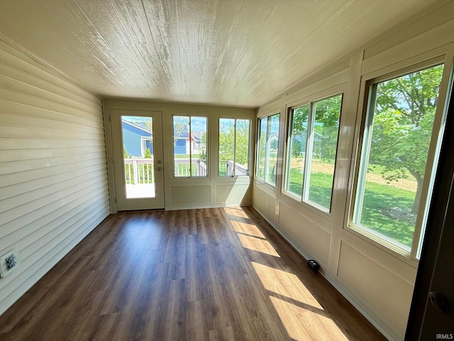 unfurnished sunroom featuring plenty of natural light and wood finished floors