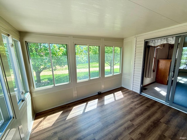 unfurnished sunroom with wood finished floors and baseboards