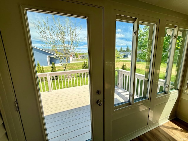 doorway to outside with dark wood-style floors