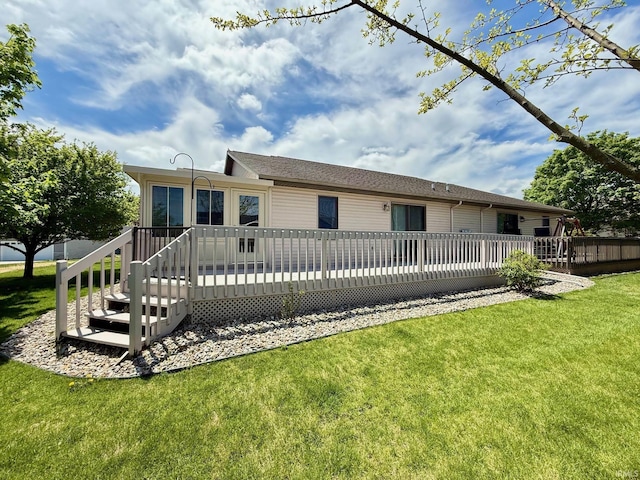 rear view of house with a yard and a wooden deck