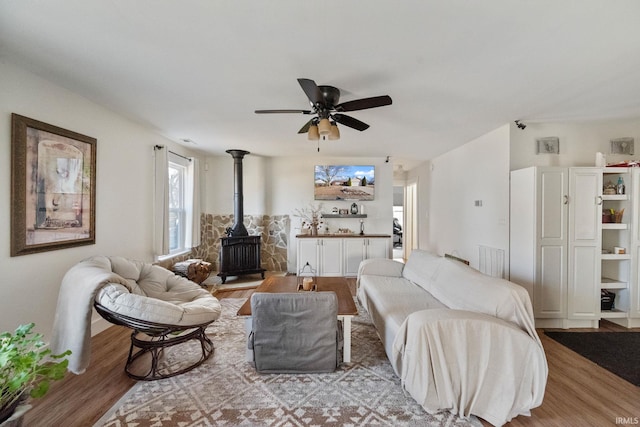 1308 Tedlee Dr, Kokomo, IN 46901 - living room with a wood stove, wood finished floors, and a ceiling fan