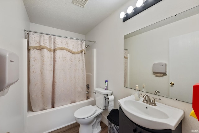1308 Tedlee Dr, Kokomo, IN 46901 - full bath featuring wood finished floors, toilet, shower / bath combo, vanity, and a textured ceiling