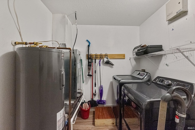 1308 Tedlee Dr, Kokomo, IN 46901 - laundry area with electric water heater, independent washer and dryer, wood finished floors, and a textured ceiling