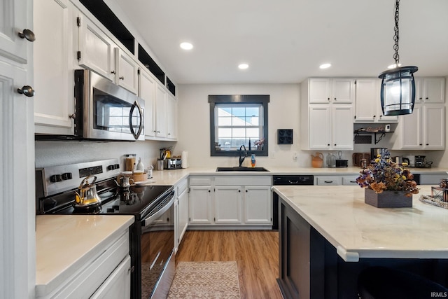 1308 Tedlee Dr, Kokomo, IN 46901 - kitchen featuring black appliances, a sink, light wood-type flooring, white cabinets, and recessed lighting