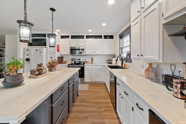 1308 Tedlee Dr, Kokomo, IN 46901 - kitchen with appliances with stainless steel finishes, white cabinetry, a sink, recessed lighting, and pendant lighting
