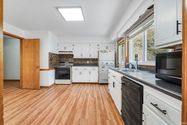3430 Woodrow Ave, Fort Wayne, IN 46805 - kitchen with black appliances, dark countertops, under cabinet range hood, light wood-type flooring, and a sink