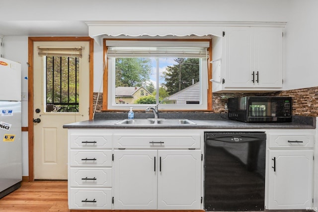 3430 Woodrow Ave, Fort Wayne, IN 46805 - kitchen with black appliances, a sink, dark countertops, and white cabinetry