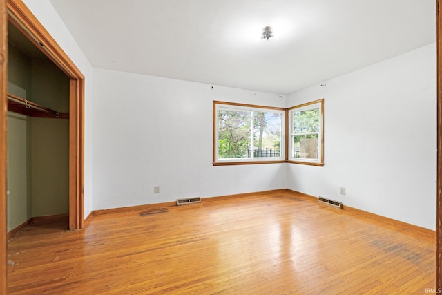3430 Woodrow Ave, Fort Wayne, IN 46805 - unfurnished bedroom featuring wood-type flooring, baseboards, and a closet