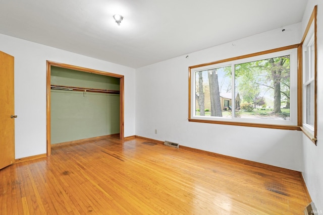 3430 Woodrow Ave, Fort Wayne, IN 46805 - unfurnished bedroom featuring light wood finished floors, a closet, and baseboards