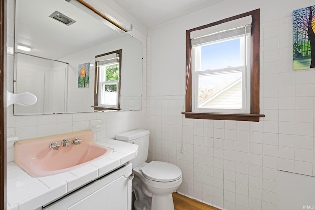 3430 Woodrow Ave, Fort Wayne, IN 46805 - bathroom featuring tile walls, toilet, vanity, and wood finished floors