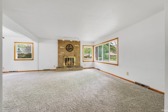 3430 Woodrow Ave, Fort Wayne, IN 46805 - unfurnished living room with track lighting, carpet, baseboards, and a stone fireplace