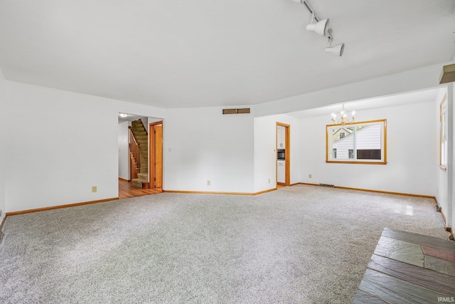 3430 Woodrow Ave, Fort Wayne, IN 46805 - unfurnished living room featuring carpet flooring, a chandelier, baseboards, and stairway