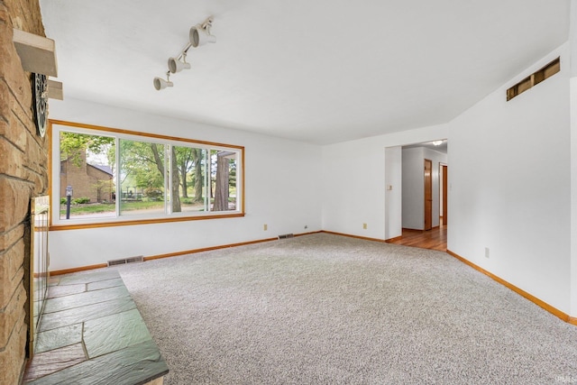 3430 Woodrow Ave, Fort Wayne, IN 46805 - unfurnished room featuring carpet, baseboards, rail lighting, and a fireplace