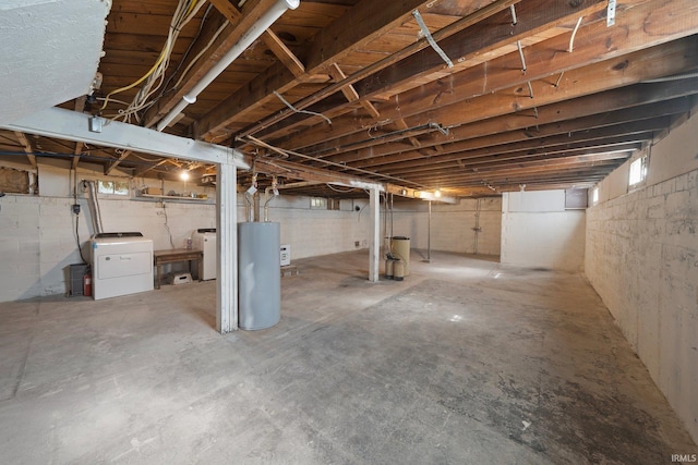 unfinished basement with gas water heater and independent washer and dryer