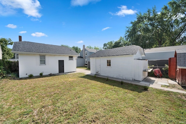 back of property with an outbuilding and a shed