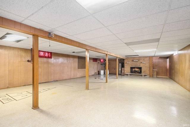 56226 Tanglewood Ln, Osceola, IN 46561 - finished basement featuring wood walls, a fireplace, a drop ceiling, and water heater
