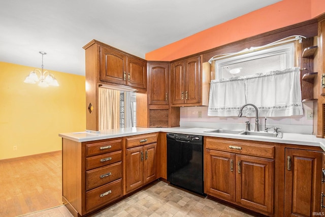 56226 Tanglewood Ln, Osceola, IN 46561 - kitchen featuring black dishwasher, a sink, a peninsula, a chandelier, and light countertops