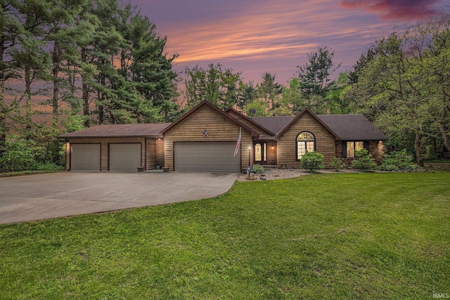 view of front of home with driveway, a garage, and a front lawn