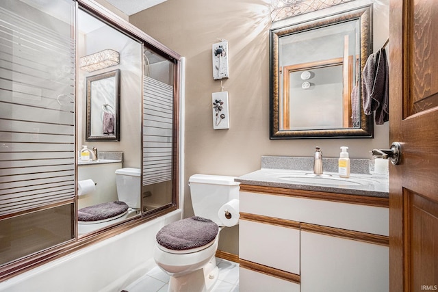 full bath featuring toilet, vanity, combined bath / shower with glass door, and tile patterned floors