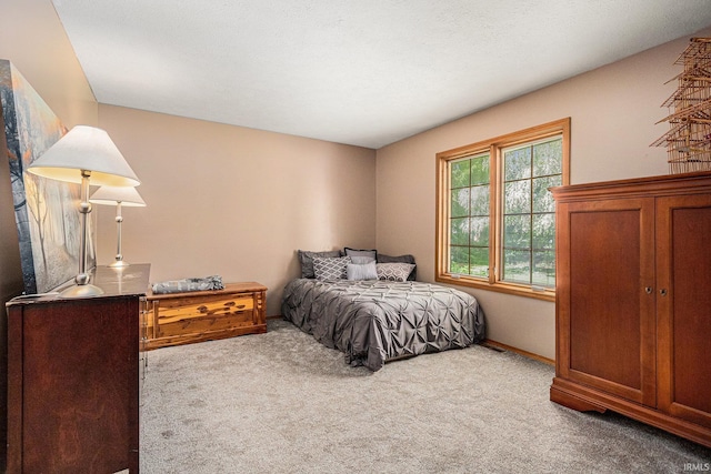 bedroom featuring carpet flooring and baseboards