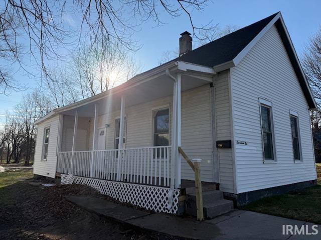 1710 Sibley Ave, South Bend, IN 46628 - view of front of home featuring a porch and a chimney