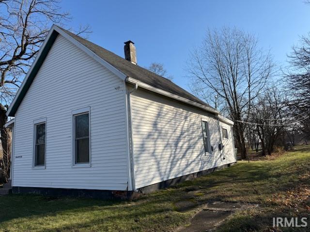 1710 Sibley Ave, South Bend, IN 46628 - view of home's exterior with a chimney and a yard