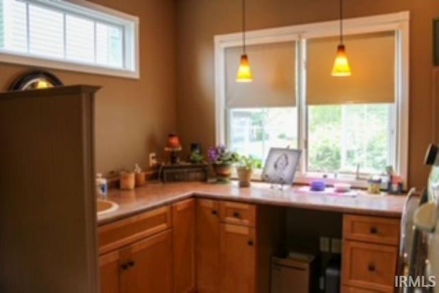 127 W Mill St, Bremen, IN 46506 - kitchen with light countertops, decorative light fixtures, and brown cabinets