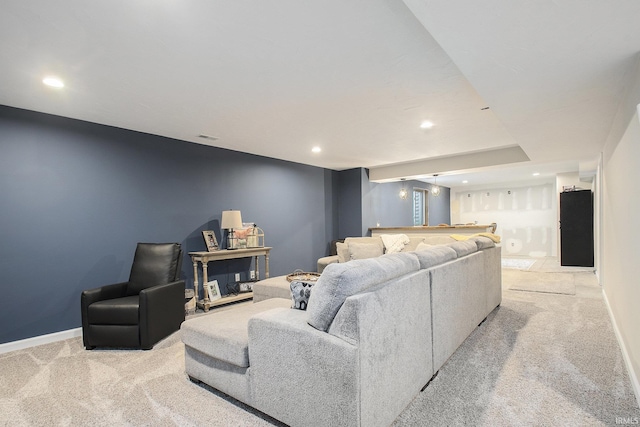 living area featuring light carpet, baseboards, and recessed lighting