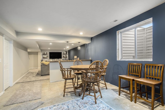 dining space with concrete floors, baseboards, and recessed lighting