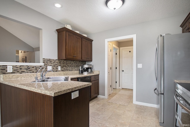 kitchen featuring a sink, freestanding refrigerator, oven, light countertops, and decorative backsplash