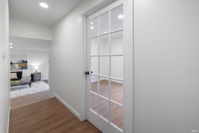 hall with wood finished floors, baseboards, and recessed lighting