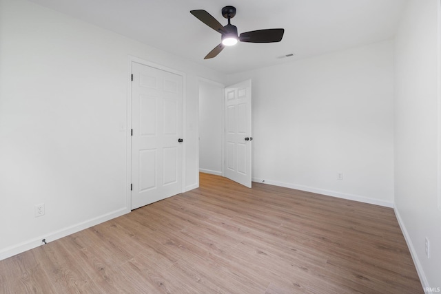 unfurnished bedroom featuring wood finished floors, baseboards, and ceiling fan