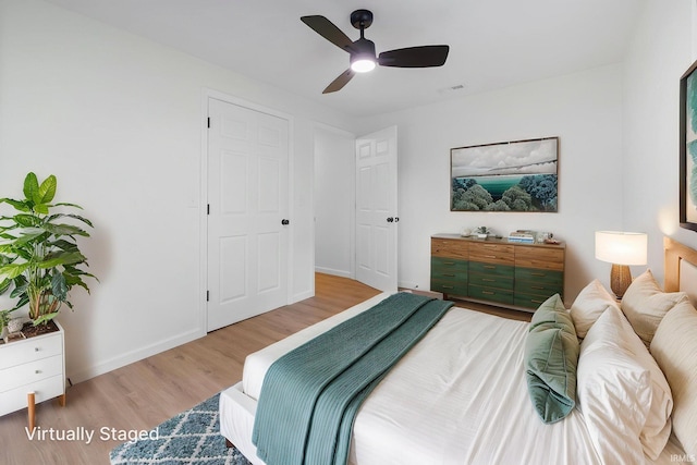 bedroom with wood finished floors, baseboards, and ceiling fan