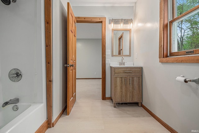 5480 E 900 N, Syracuse, IN 46567 - bathroom featuring wood finished floors, vanity, baseboards, and bathtub / shower combination