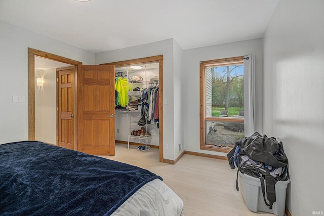 5480 E 900 N, Syracuse, IN 46567 - bedroom with light wood finished floors, a closet, baseboards, and a walk in closet