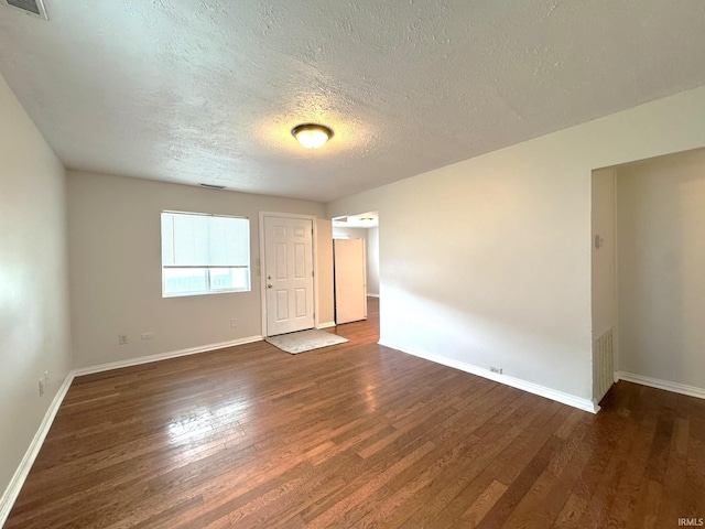 819 N Mccann St, Kokomo, IN 46901 - unfurnished room featuring dark wood finished floors, a textured ceiling, and baseboards