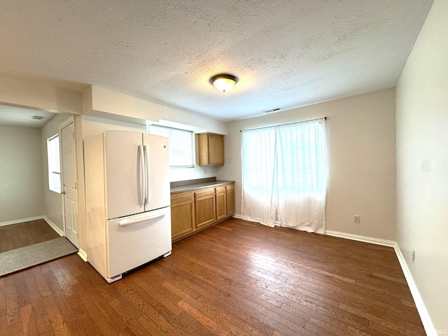 819 N Mccann St, Kokomo, IN 46901 - kitchen featuring freestanding refrigerator, dark wood-style flooring, brown cabinetry, baseboards, and plenty of natural light