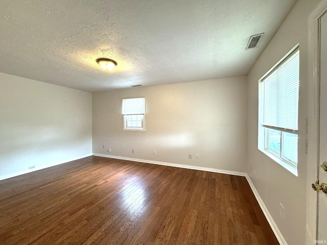 819 N Mccann St, Kokomo, IN 46901 - spare room with a textured ceiling, dark wood-type flooring, and baseboards