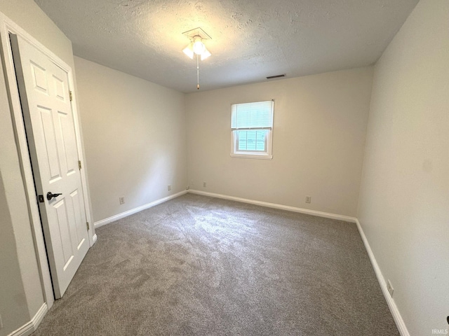 819 N Mccann St, Kokomo, IN 46901 - carpeted empty room featuring a textured ceiling and baseboards