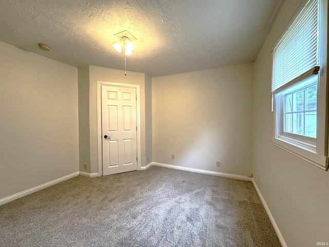 819 N Mccann St, Kokomo, IN 46901 - carpeted empty room featuring a textured ceiling, baseboards, and a smoke detector