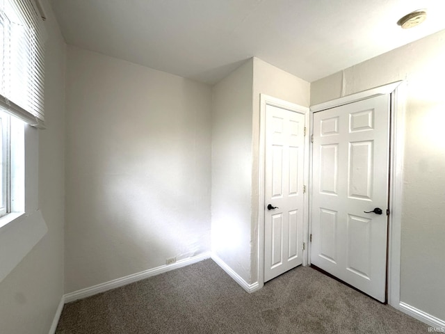 819 N Mccann St, Kokomo, IN 46901 - unfurnished bedroom with carpet flooring, baseboards, and a closet