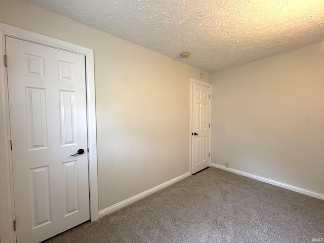 819 N Mccann St, Kokomo, IN 46901 - carpeted spare room featuring baseboards, a textured ceiling, and a smoke detector