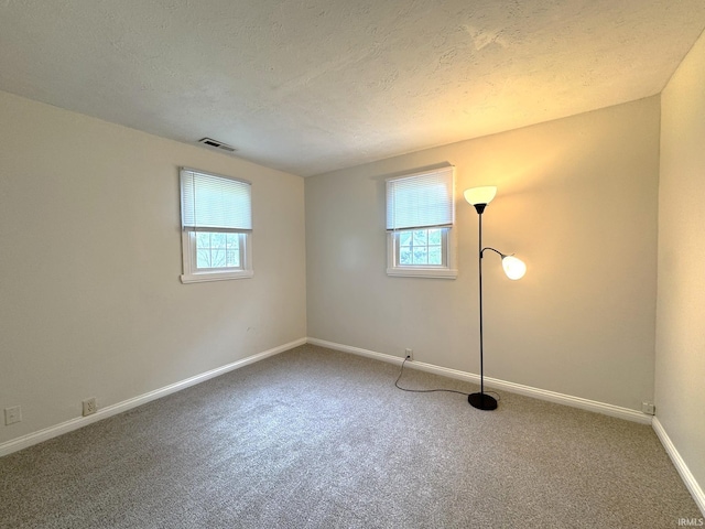 819 N Mccann St, Kokomo, IN 46901 - carpeted empty room with baseboards and a textured ceiling