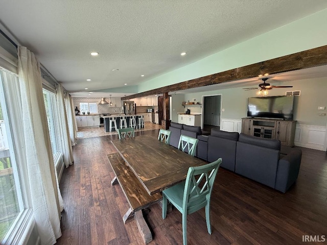 dining area featuring dark wood finished floors, a wainscoted wall, recessed lighting, a textured ceiling, and ceiling fan